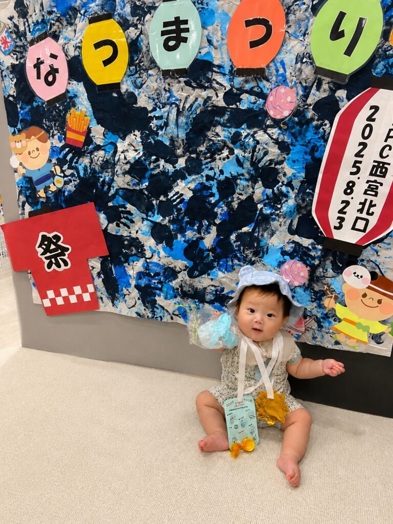 夏祭りのフォトブースで写真を撮る0歳児